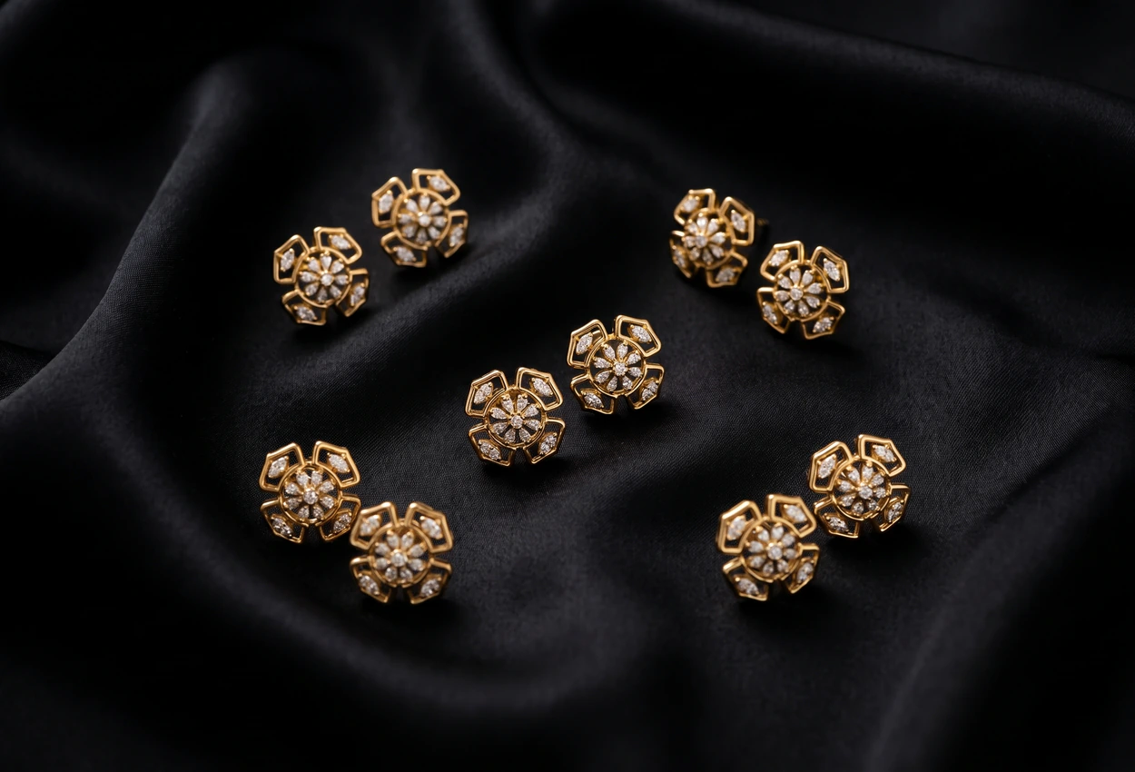 D&A Jewellery gold stud earrings on black silk